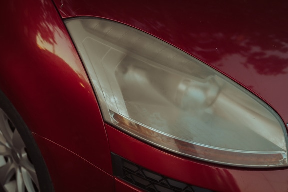 Blurry headlight of a red car