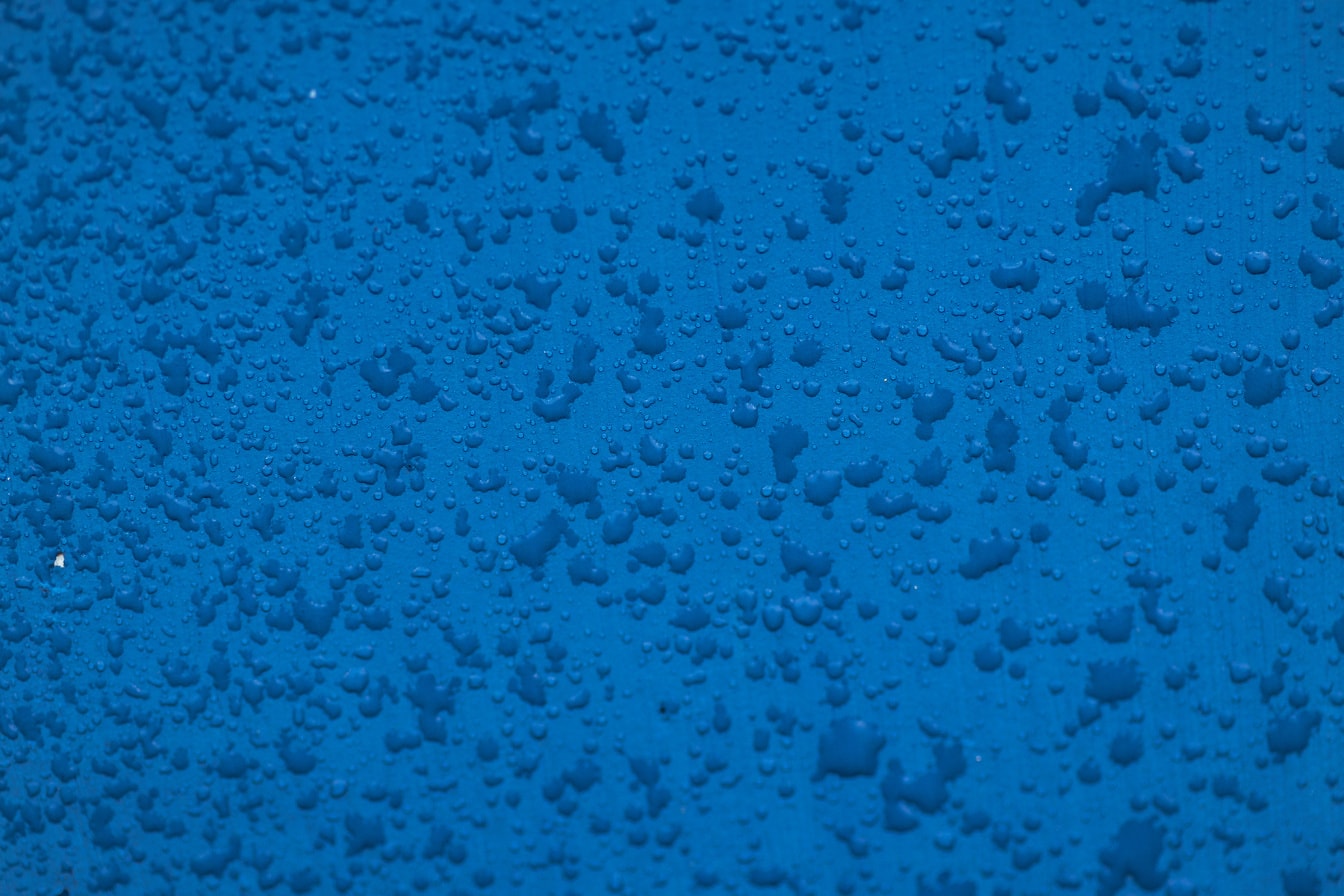 Texture of water drops on a blue surface