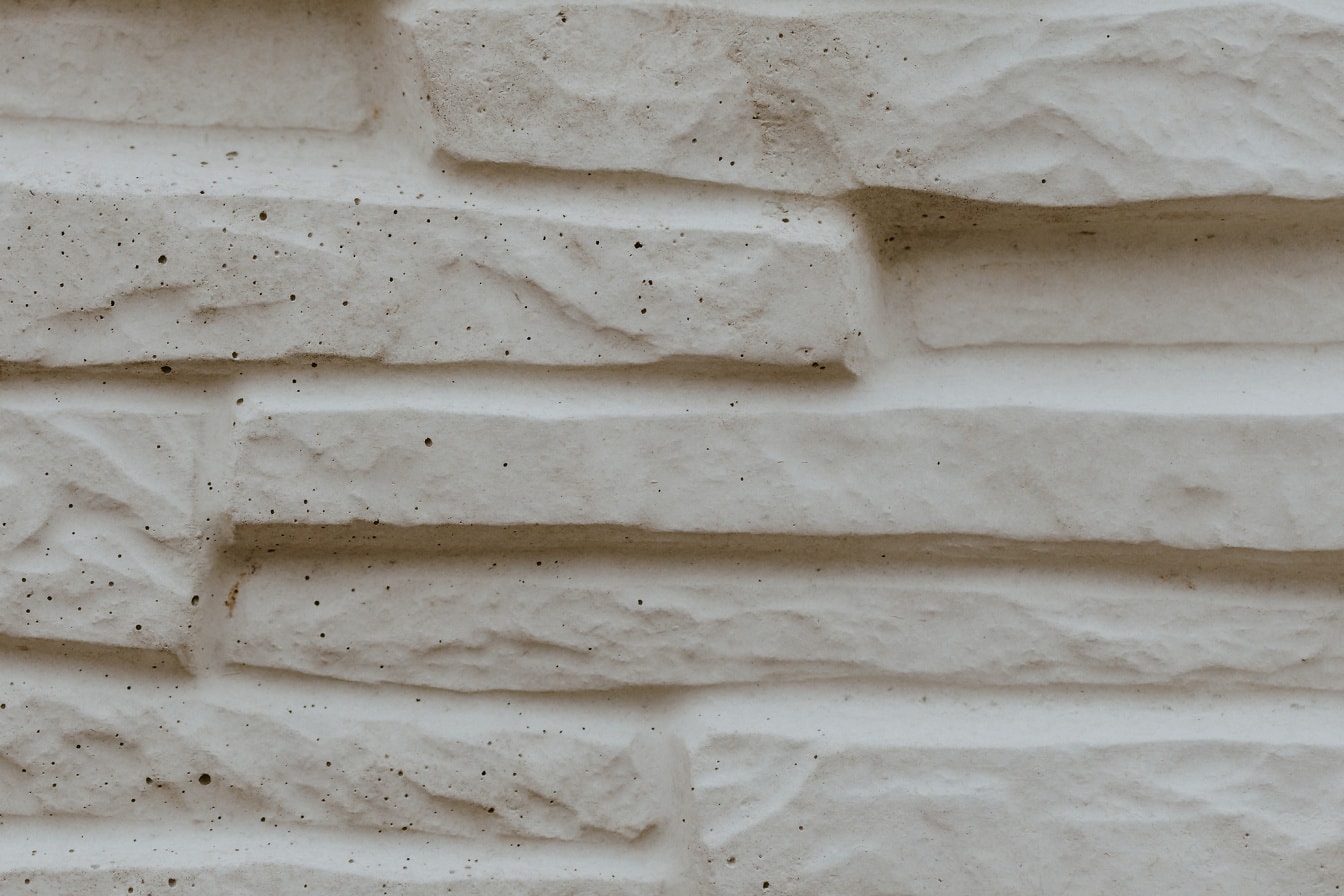 Texture of artificial beige stone wall