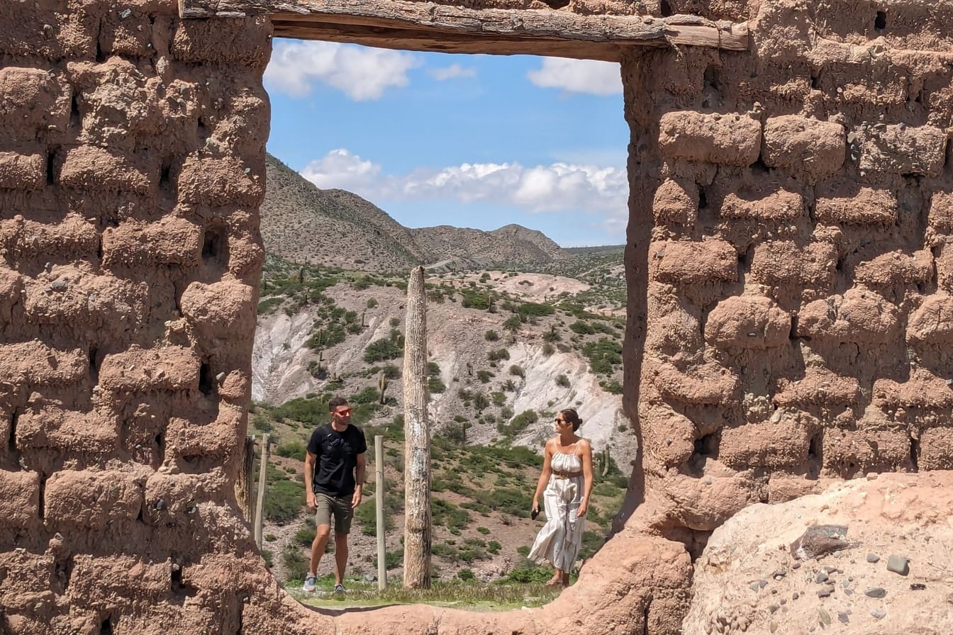 Ruin of doorway in foreground with a man and woman in background