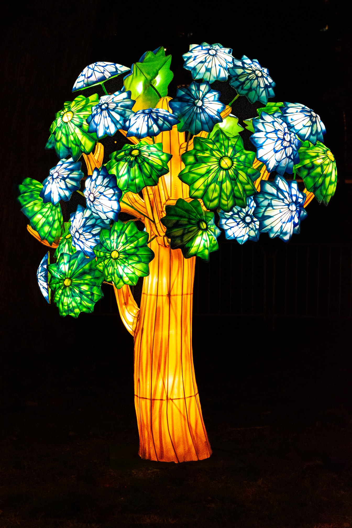 Glowing sculpture of tree with flowers at Chinese festival of light