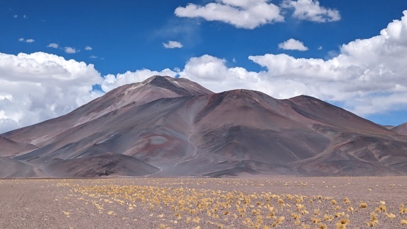Large mountain in south America with a flat field on plateau in front of it