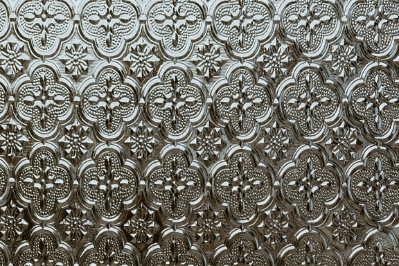 Texture of a molded glass with ornament arabesque pattern in baroque style