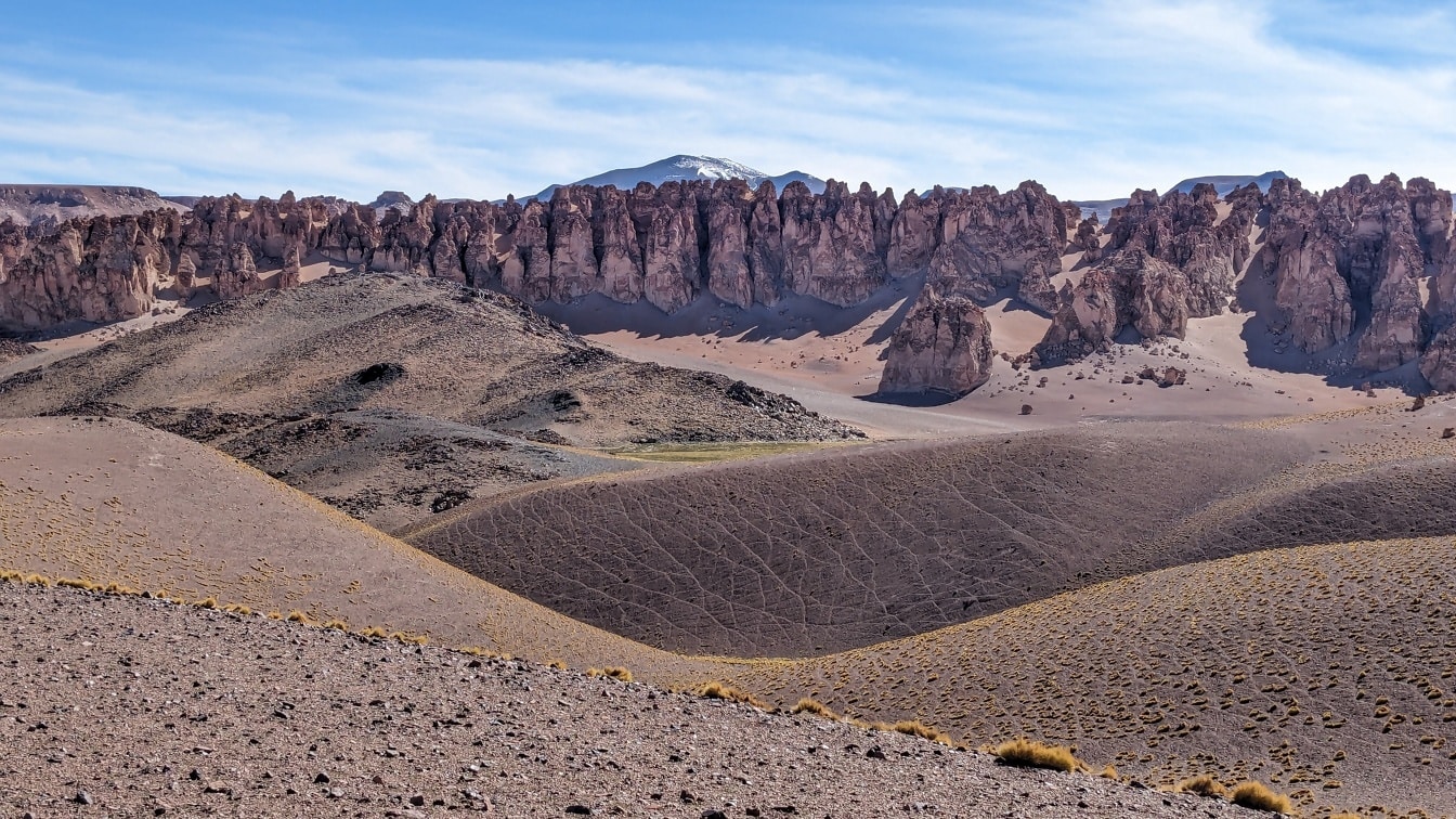 Sandy geoformations with rocky mountain cliffs in Galan plateau in natural reserve in Argentina