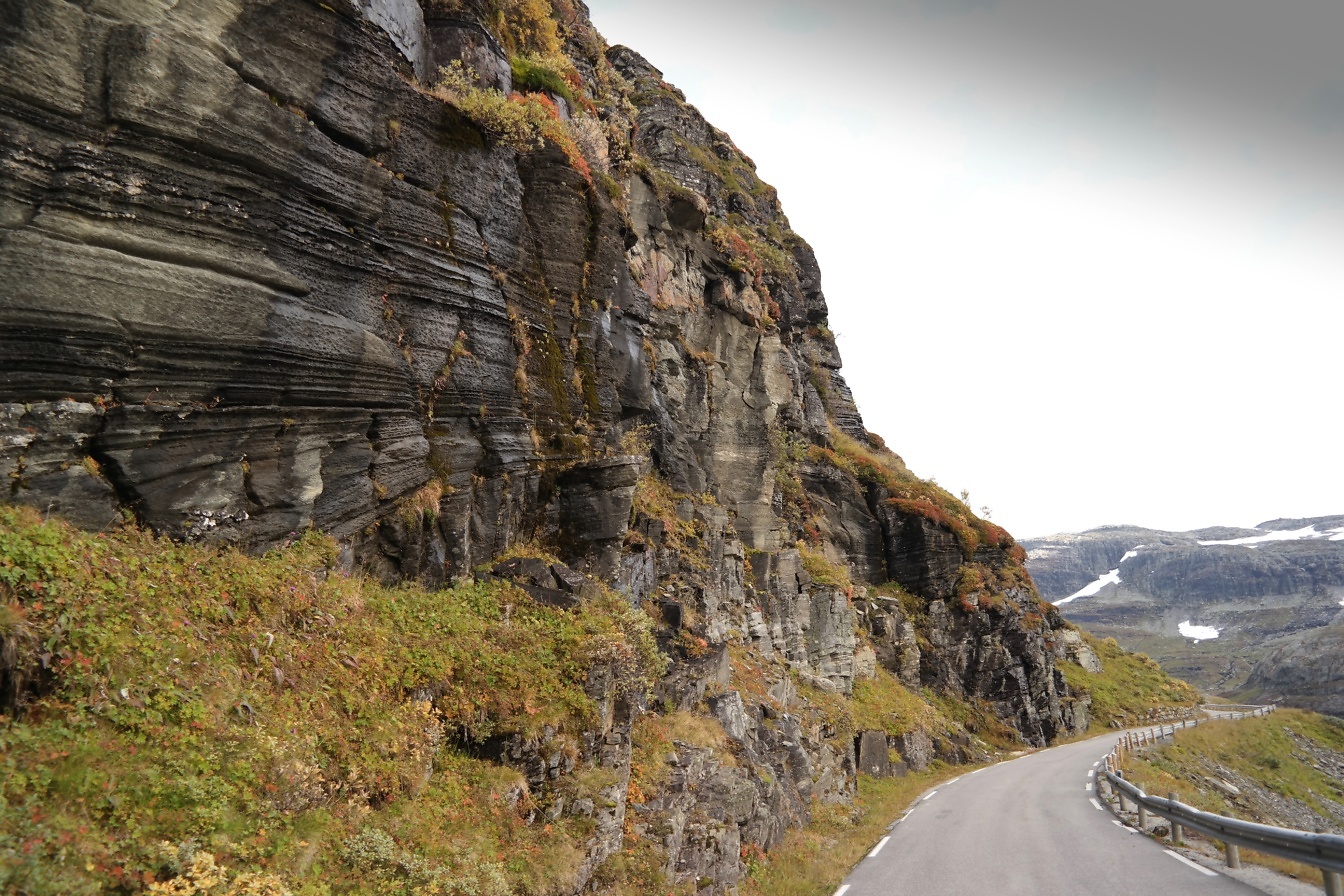 노르웨이의 산들에 있는 경사면의 절벽 옆 도로