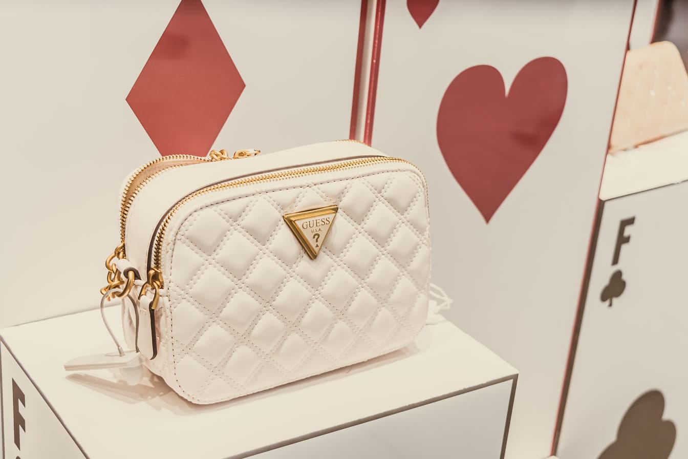 White purse on a white box in fashion store