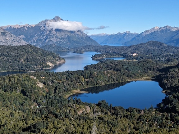 ทะเลสาบที่ล้อมรอบด้วยต้นไม้และภูเขาในอุทยานแห่งชาติ Nahuel Huapi ในอาร์เจนตินา