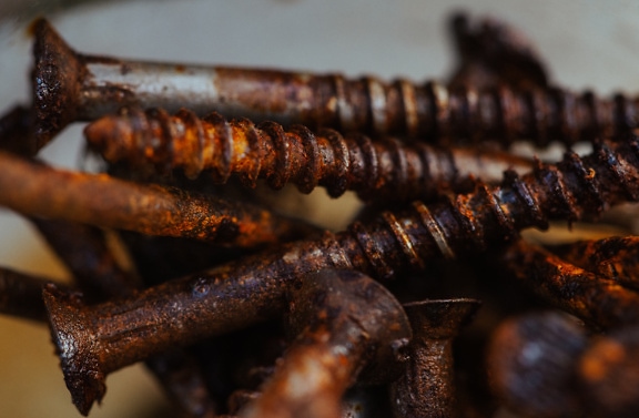 Close-up of pile of rusty screws