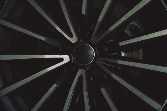 Texture of the black wheel of a sports car made of aluminum alloy