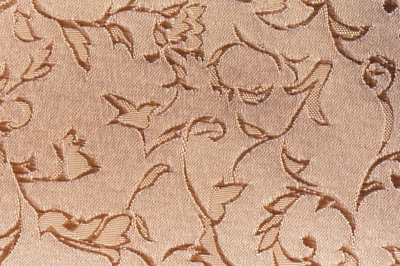 Textura en primer plano de una tela de damasco marrón