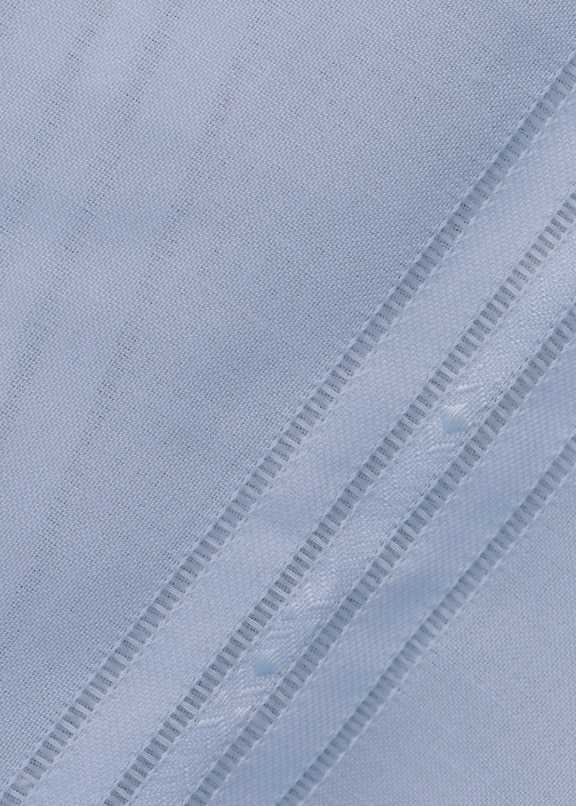Texture ravvicinata di un tessuto di cotone bianco con linee diagonali