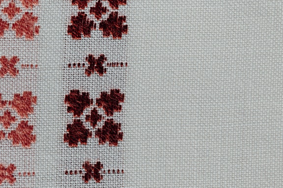 Texture ravvicinata di tela di lino con ricamo tradizionale a mano