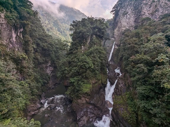 The Devil’s waterfall in the Andes in Banos in natural park of Ecuador