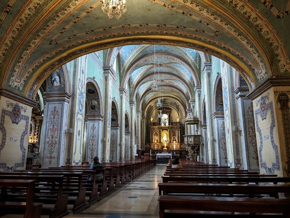 Interior con muchas bancas del templo católico de la Orden Agustiniana y convento de San Agustín en la ciudad de Quito en Ecuador