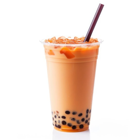 Cup of refreshing cold Thai milk tea with drinking straw