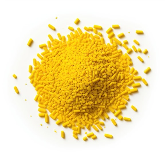 Pile of yellow sprinkle on pure white background