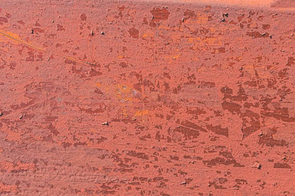 Kết cấu của bề mặt kim loại gỉ với sơn màu đỏ bong ra
