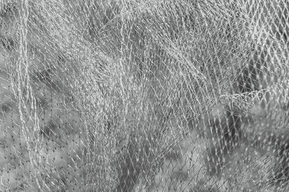 Tekstur hitam dan putih dari jaring nilon yang terbuat dari polivinil klorida