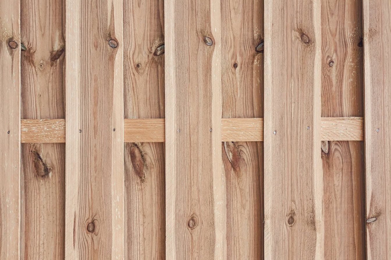 Texture wooden panel made of vertically stacked thin hardwood slats with knots