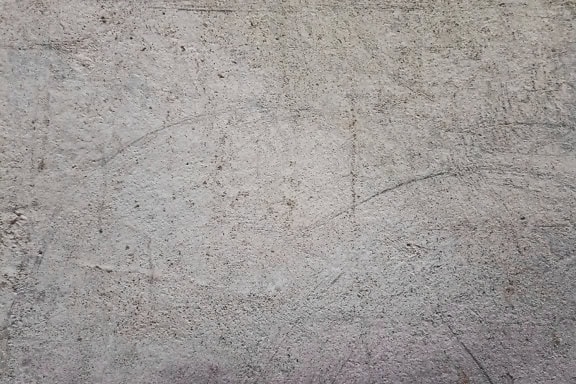 Tekstura brudnej, szarawej ściany z chropowatą powierzchnią