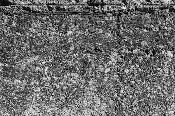 Texture in bianco e nero di un vecchio muro di cemento