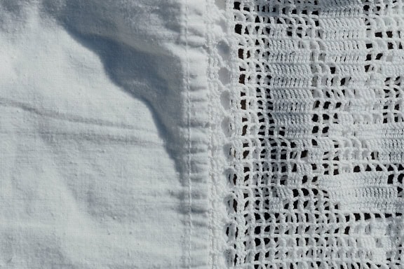 Textur aus weißem Baumwollstoff mit handgewebter Spitze