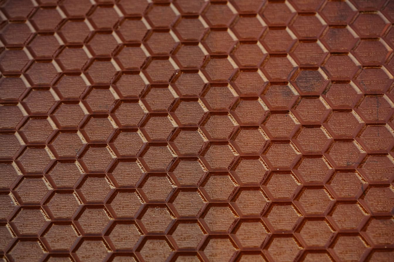 Texture of semi-transparent brown glass with honeycomb texture surface