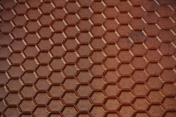 Tekstura półprzezroczystego brązowego szkła z powierzchnią o strukturze plastra miodu