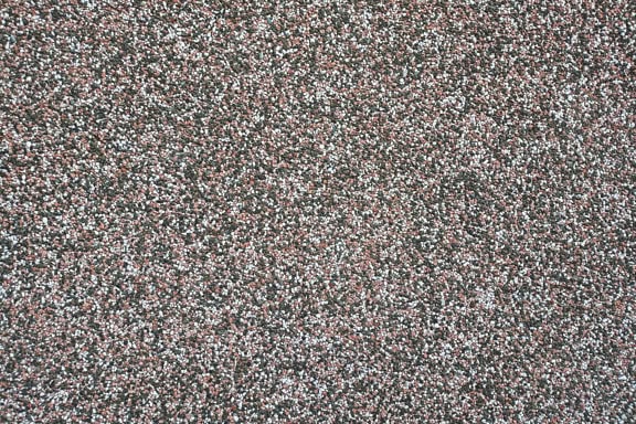 พื้นผิวของผนังที่มีซุ้ม demit ด้วยหินหลากสีขนาดเล็ก
