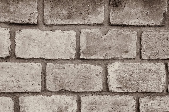 Sepiatextuur van een bakstenen muur die uit oude horizontaal gestapelde kleine bakstenen wordt gemaakt