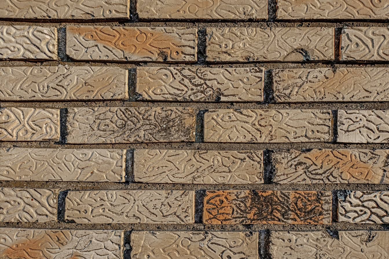 Texture of a dirty brick wall made out of horizontally stacked yellowish facade bricks