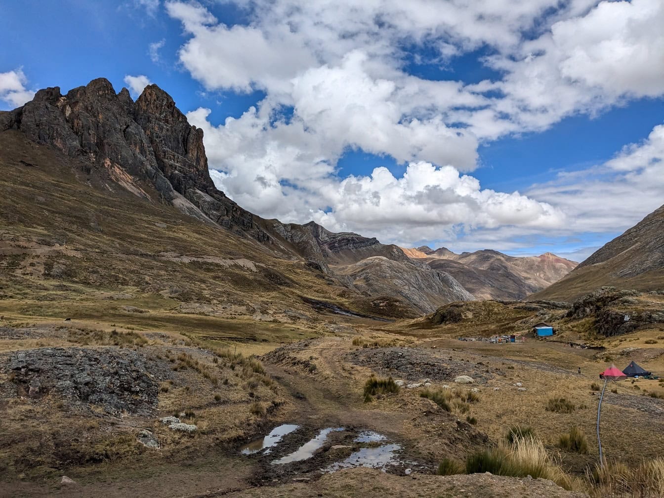 Mountain range with camping site in a valley at Cordillera Huayhuash mountain range in the Andes of Peru