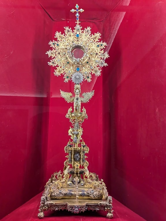 Peruvian religious heritage a ornate golden object with a cross, on display in the  Jesuit church in Arequipa in Peru