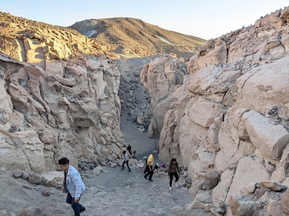 Embercsoport sétál egy kanyonban Arequipában, Peruban