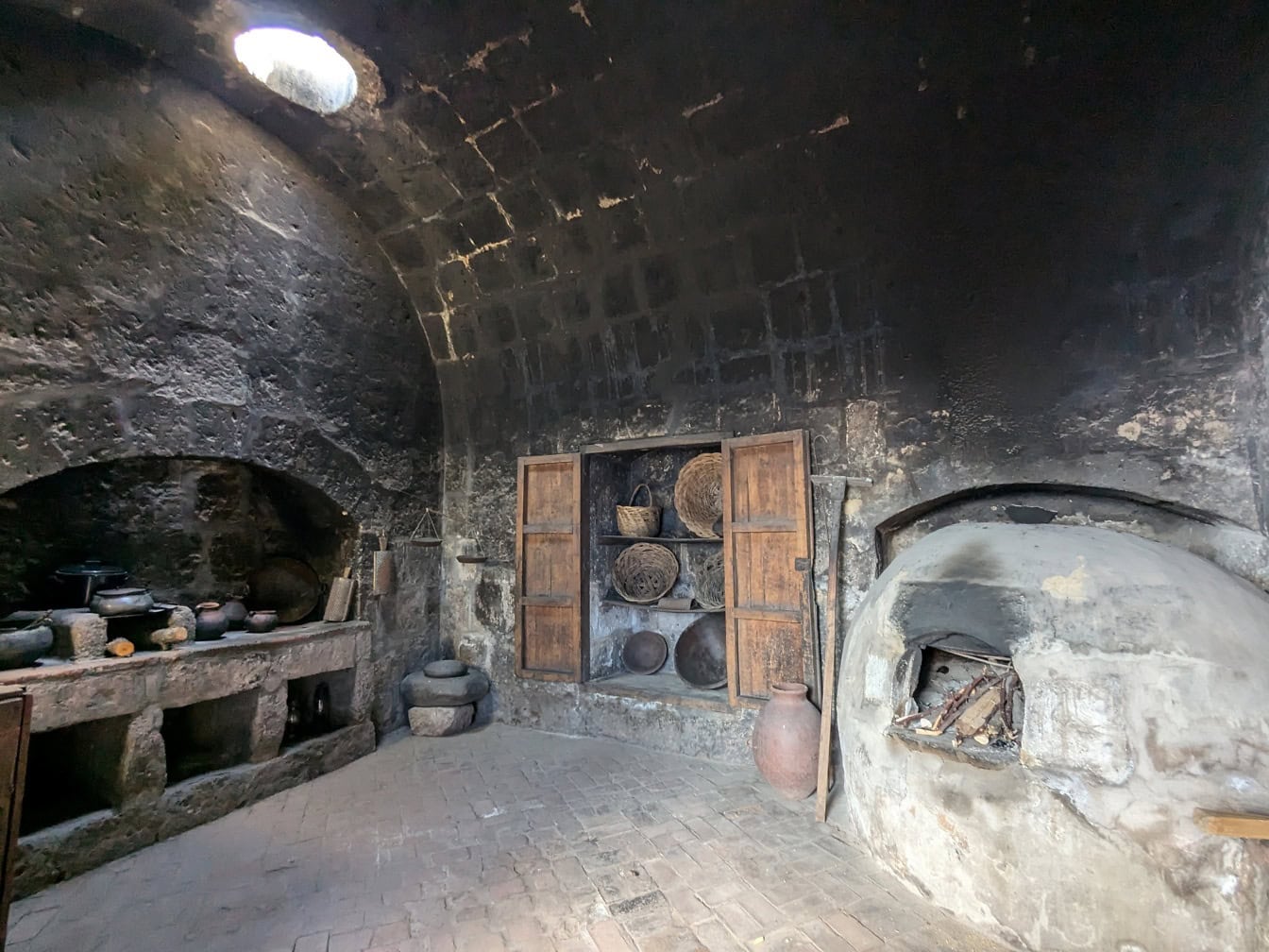 Keskiaikainen keittiö, jossa on kiviuuni ja hyllyt terrakottaruukuilla Santa Catalinan luostarissa Arequipassa Perussa;