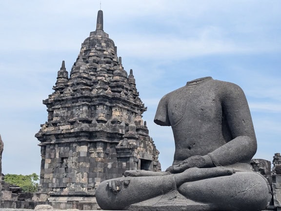 Statue of a man without head at Prambanan temple, a Hindu temple in Yogyakarta in southern Java, Indonesia