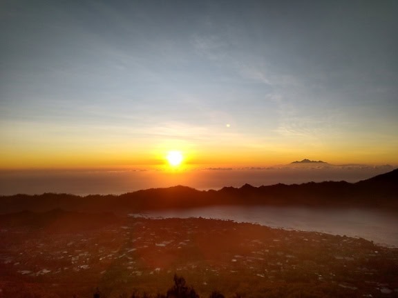 Sunrise over a settlement covered with fog