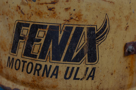 Close-up of an old rusty metal container of motor oil with an inscription of fenix