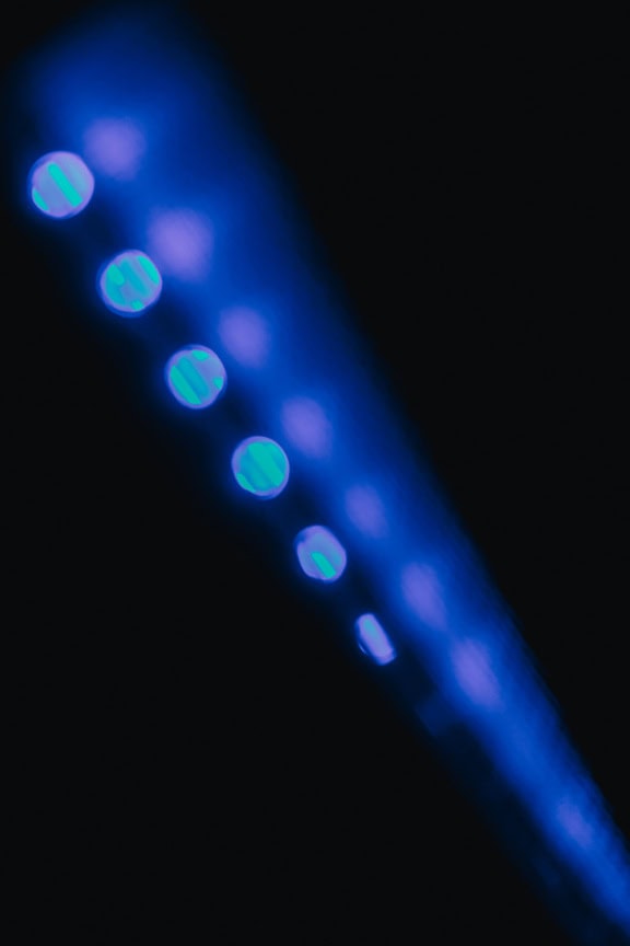 Blurry reflection of blue light from LED diodes in the dark