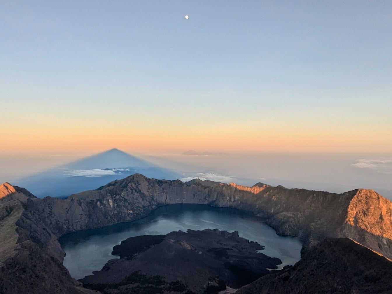 Majestic panorama at sunset of crater lake in volcanic crater on mountain Rinjani, an active volcano in Lombok in Indonesia