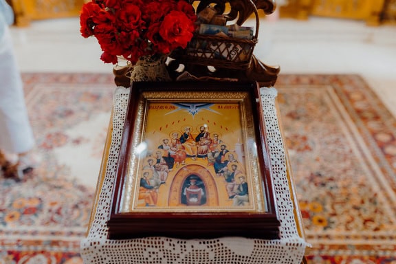 Framed picture in a church depicting twelve apostilles around Jesus Christ