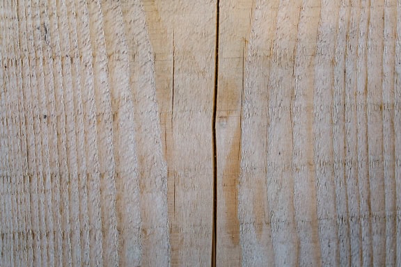 Texture of light brown wooden surface, plank with a vertical crack