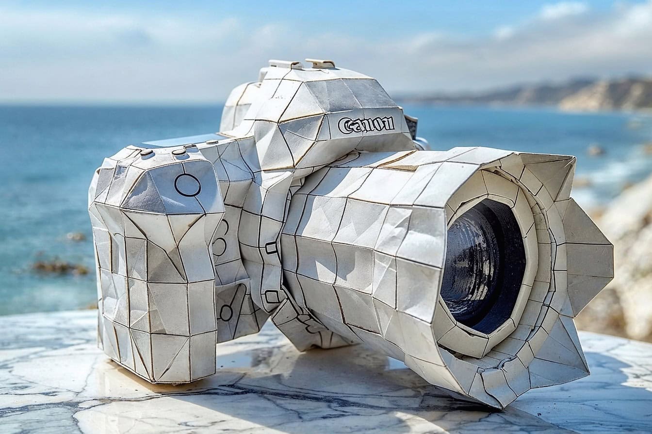 A white Canon camera made of paper in an origami style