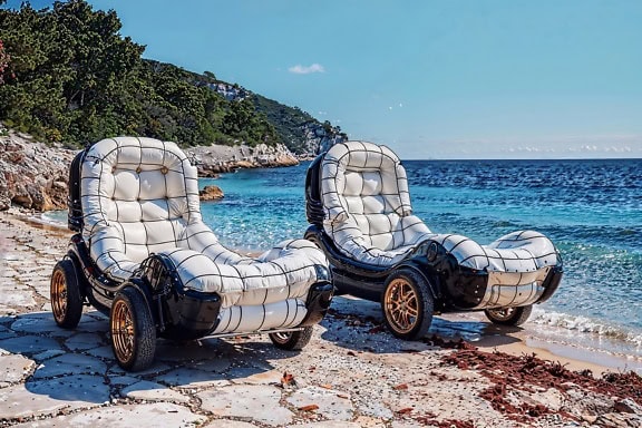 Two black and white armchairs on a wheels on a beach in glamping resort