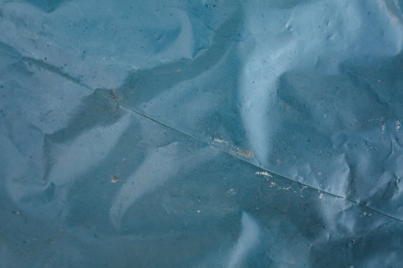 Blue-grey plastic nylon wrap, a texture of an industrial PVC folia