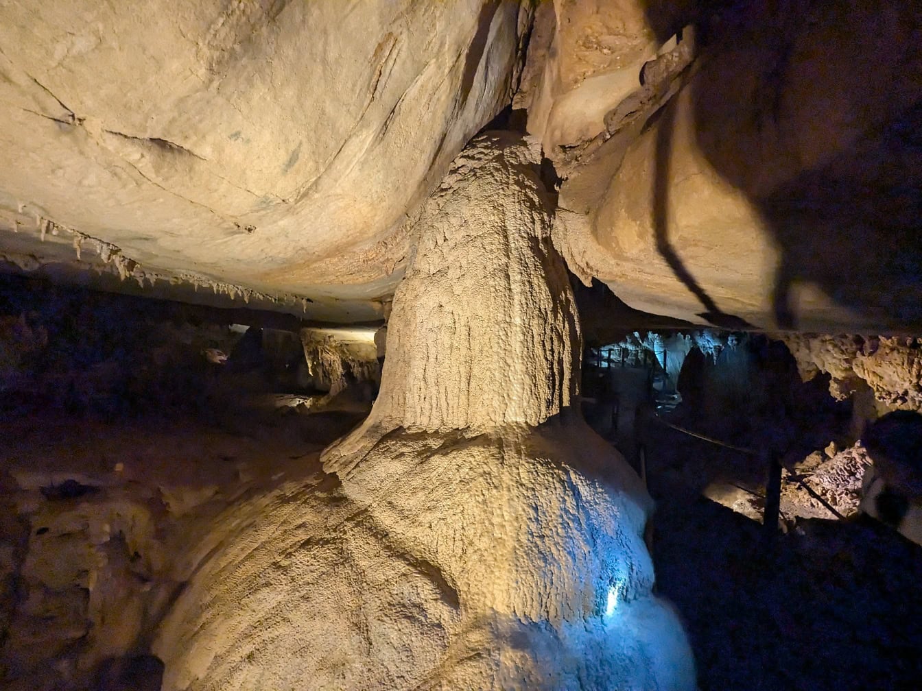 Large rock formation of a stalactite, a mineral formation that hangs from the ceiling in underground cave