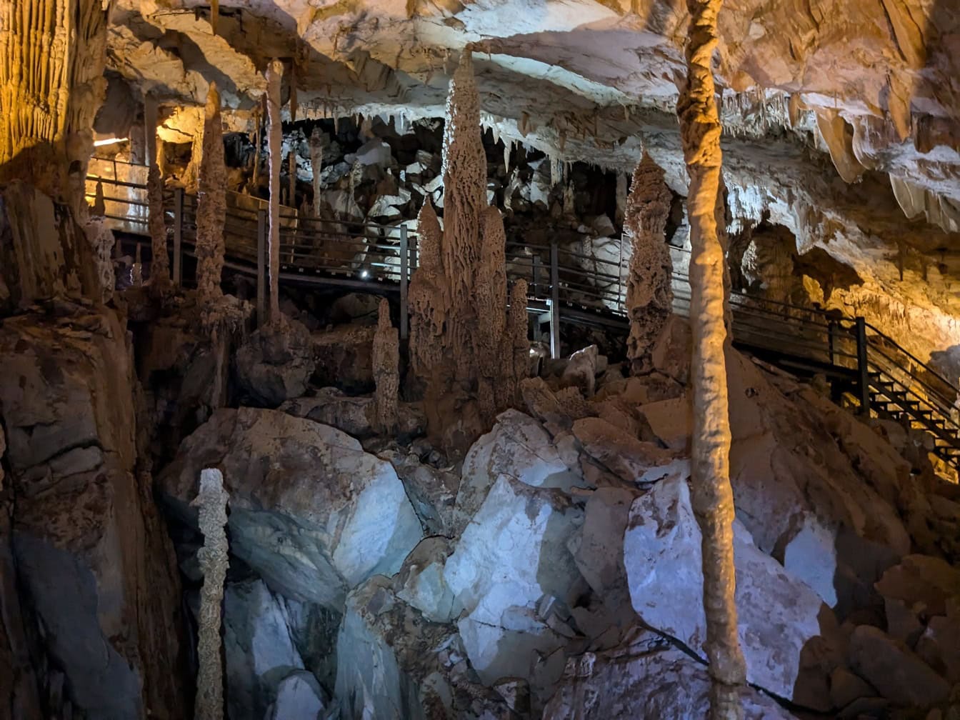 An underground cave with tall and sharp stalactites and stalagmites