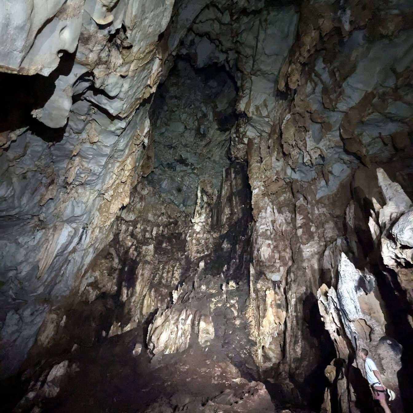 Dark underground cave with stalactite and stalagmite