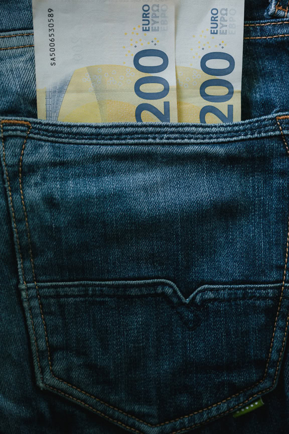 Two banknotes of two hundred euros (€200) in cash in the back pocket of jeans trousers