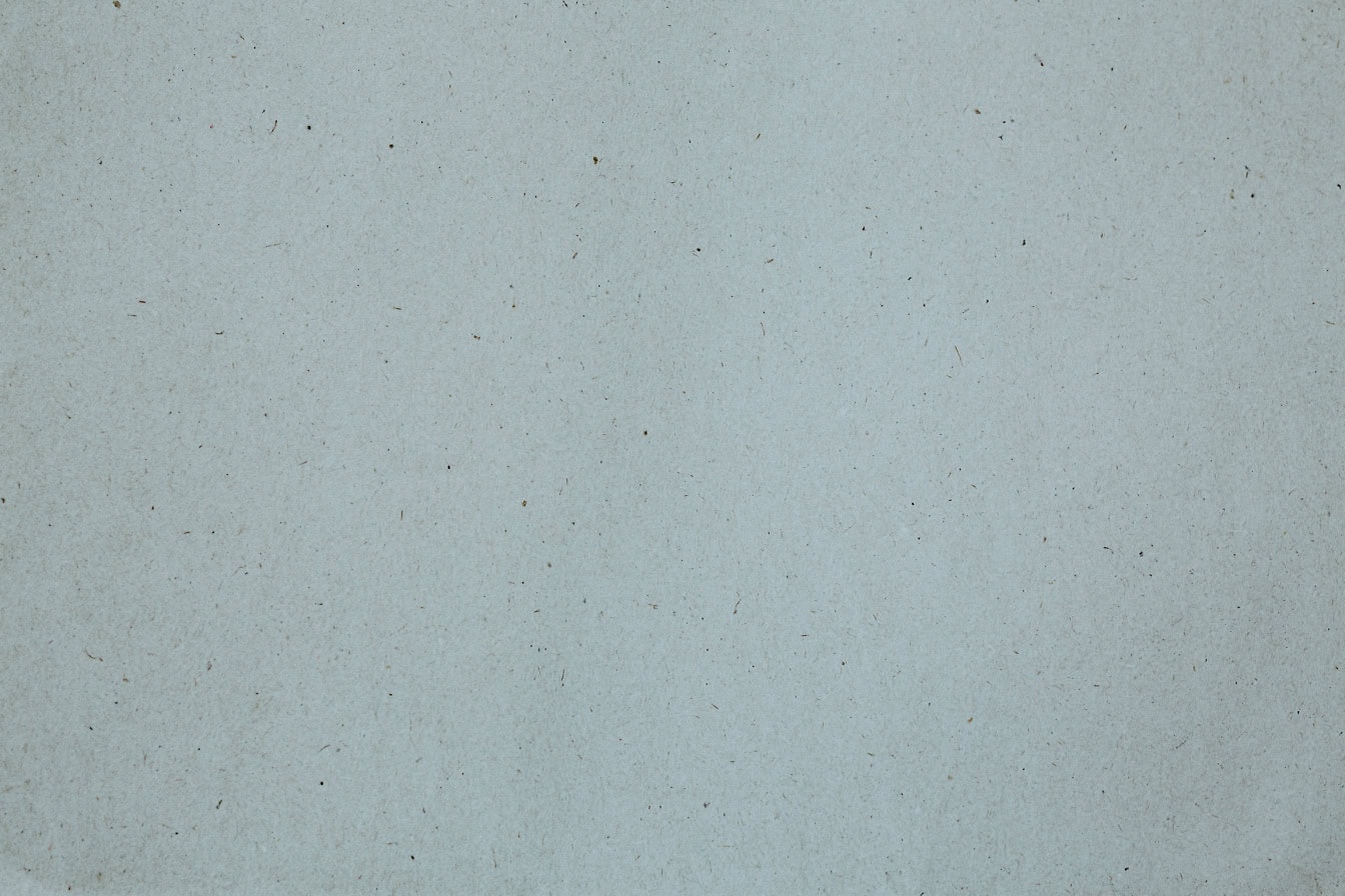 White paper surface with small specks, a texture of recycled paper